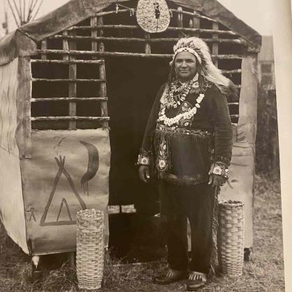 Mattaponi chief in front of housing